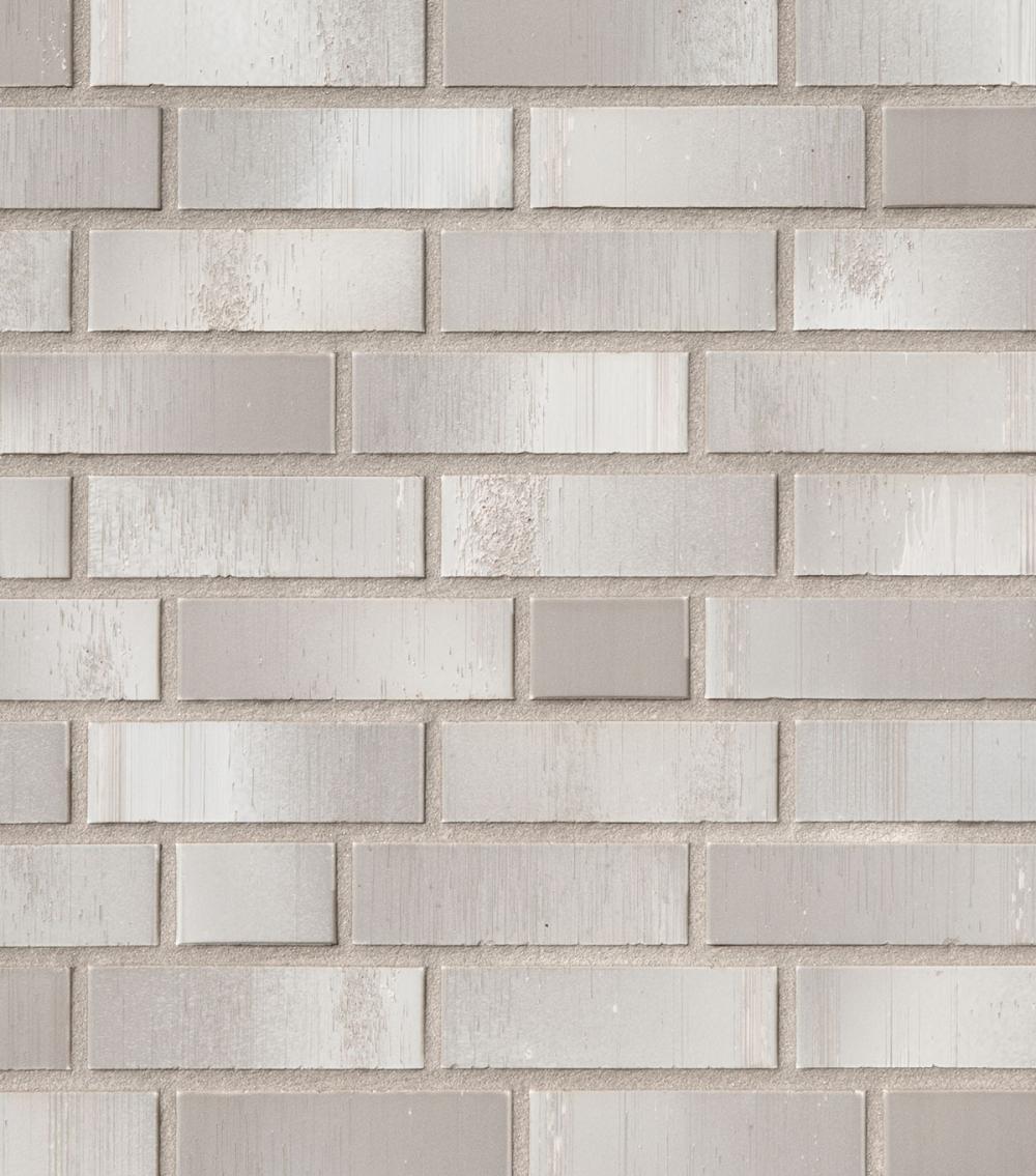 Helle Ziegelwand mit rechteckigen, beigen Steinen.