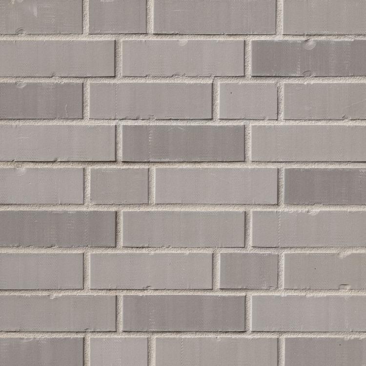 Graue Ziegelwand in gleichmäßiger Anordnung.