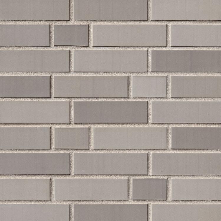 Graues Mosaikmuster aus rechteckigen Kacheln.