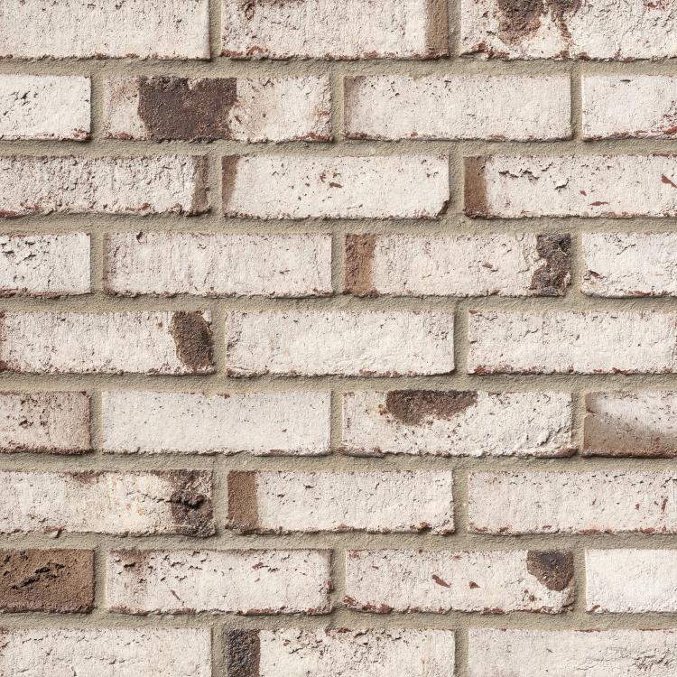 Weiß-graue Backsteinmauer mit ungleichmäßiger Textur.