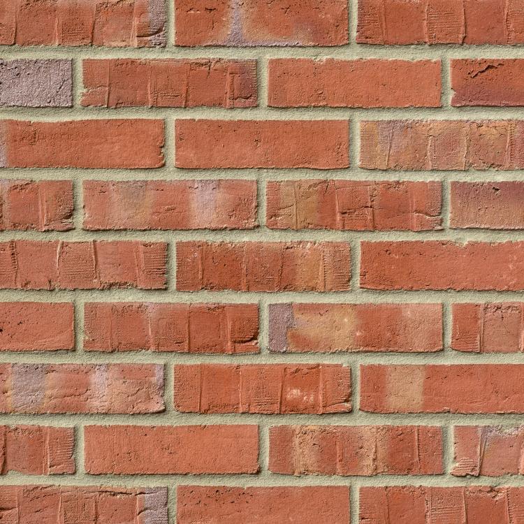 Rote Backsteinmauer mit beigem Mörtel.