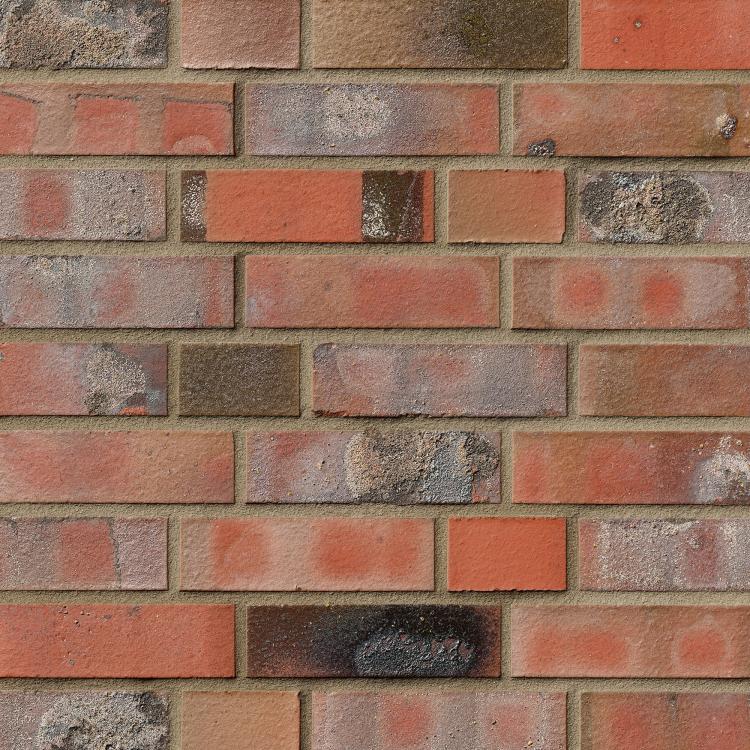 Ziegelsteinmauer in verschiedenen Rot- und Brauntönen.