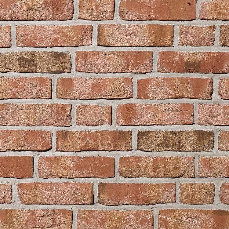 Ziegelwand mit roten Backsteinen und hellem Mörtel.