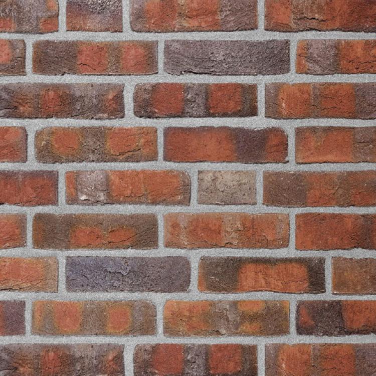 Backsteinmauer mit roten und grauen Ziegeln.