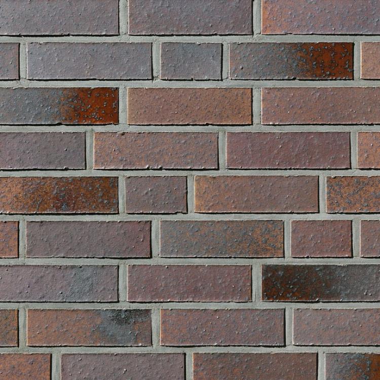 Ziegelsteinmauer mit roten und grauen Tönen.