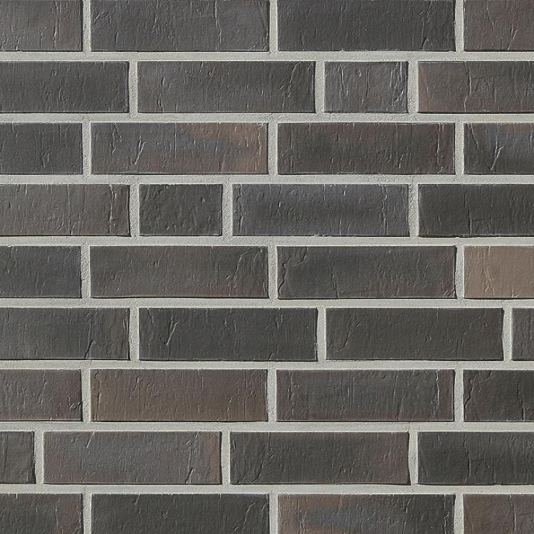 Dunkle Ziegelwand mit unterschiedlichen Grautönen.