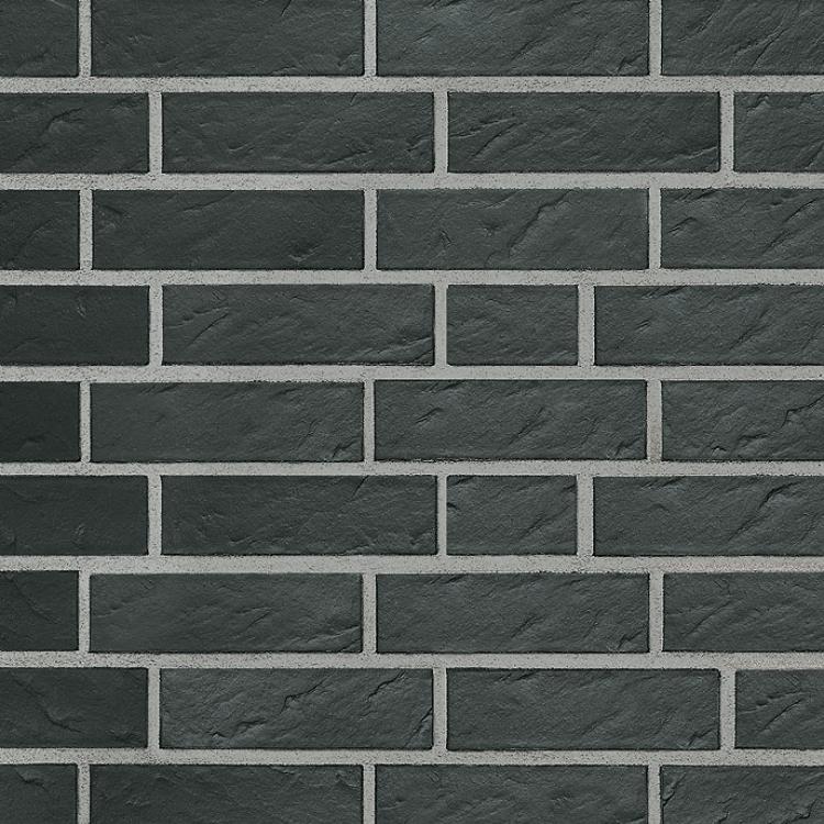 Dunkle Ziegelsteinwand mit grauen Fugen.