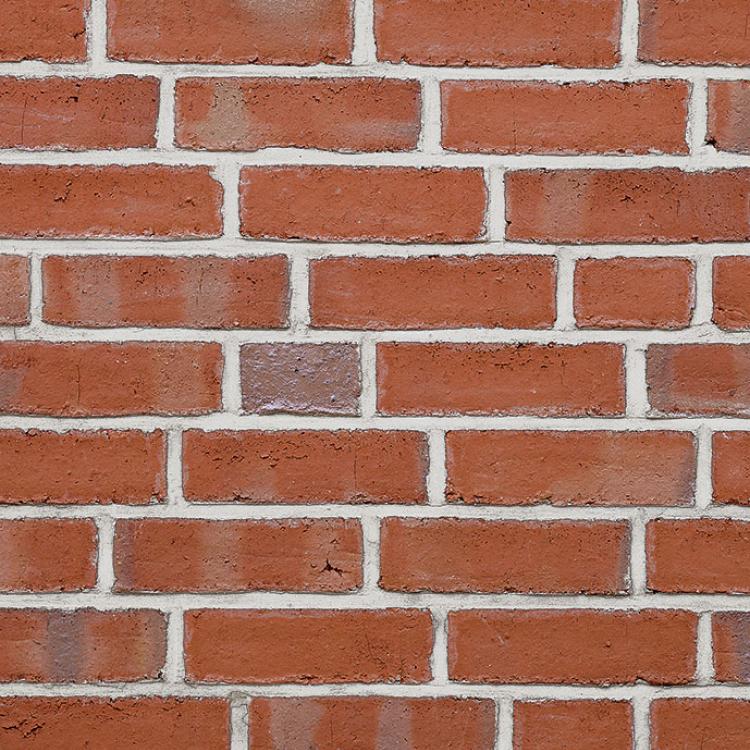 Rote Ziegelsteinmauer mit unregelmäßigem Muster.