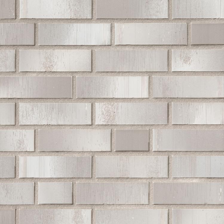 Helle Ziegelwand mit rechteckigen, beigen Steinen.