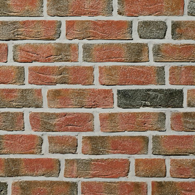 Rote und braune Ziegelwand in gleichmäßigem Muster.