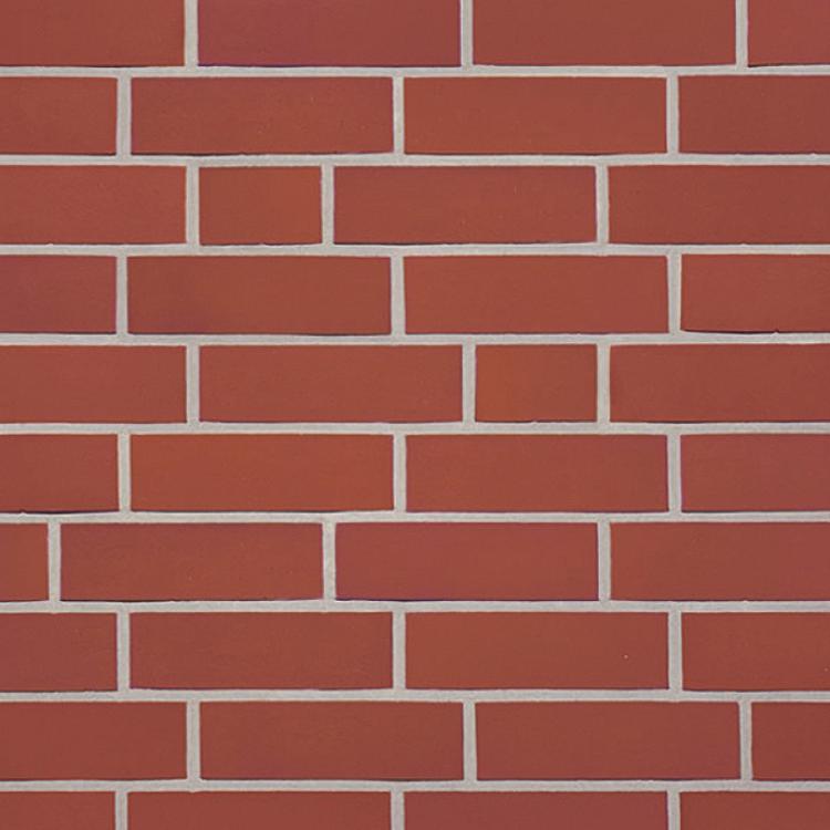 Ziegelwand mit roten Rechtecken in Mauerwerksmuster.