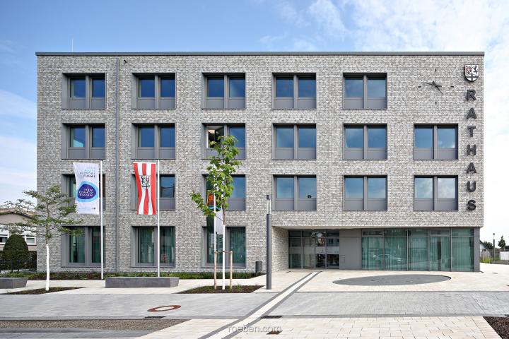 Keramik-Klinker LYON blaugrau: Rathaus Delbrück Modernes Rathausgebäude mit Glasfenstern und Fahnenmasten davor.
